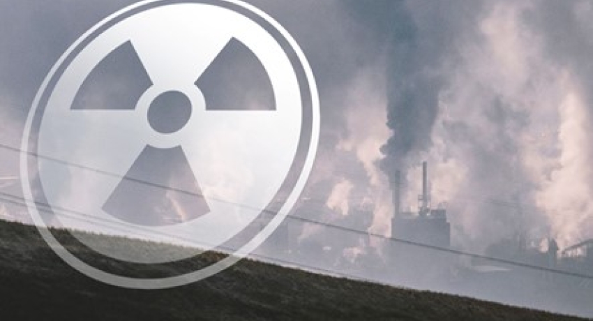 an image of a nuclear facility with a translucent radiation symbol in front