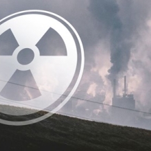 an image of a nuclear facility with a translucent radiation symbol in front