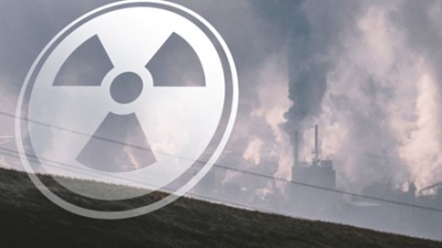 an image of a nuclear facility with a translucent radiation symbol in front